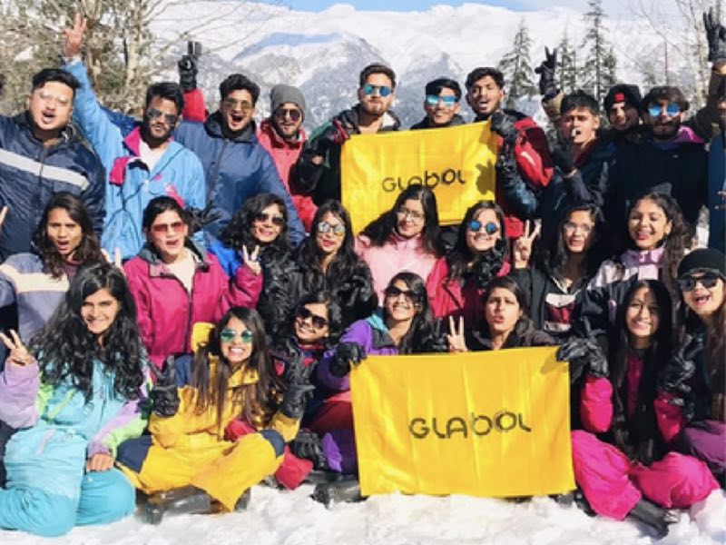 A Glabol group holding Glabol flags in the snow